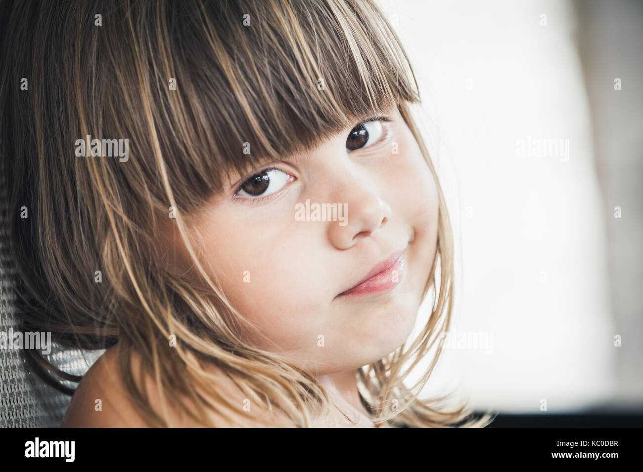 Serious Blond little girl, close-up outdoor face portrait Stock Photo