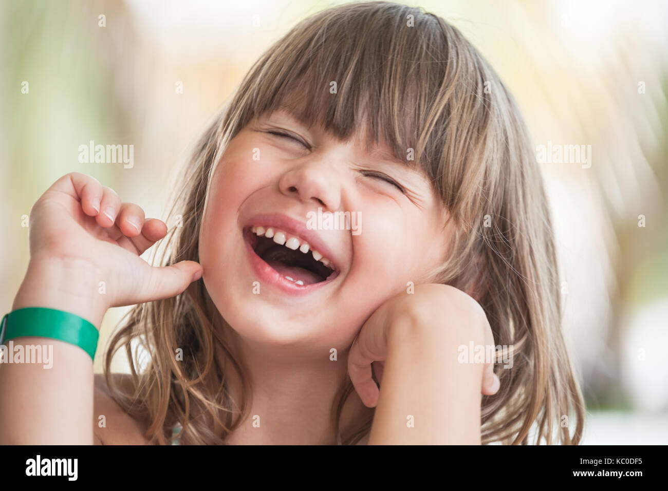 Laughing Blond Caucasian little girl, close-up outdoor face portrait Stock Photo