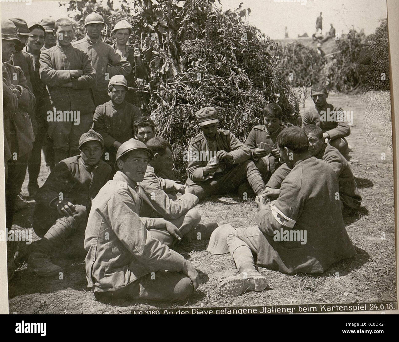 The image shows Italian prisoners of war playing cards on the Piave ...
