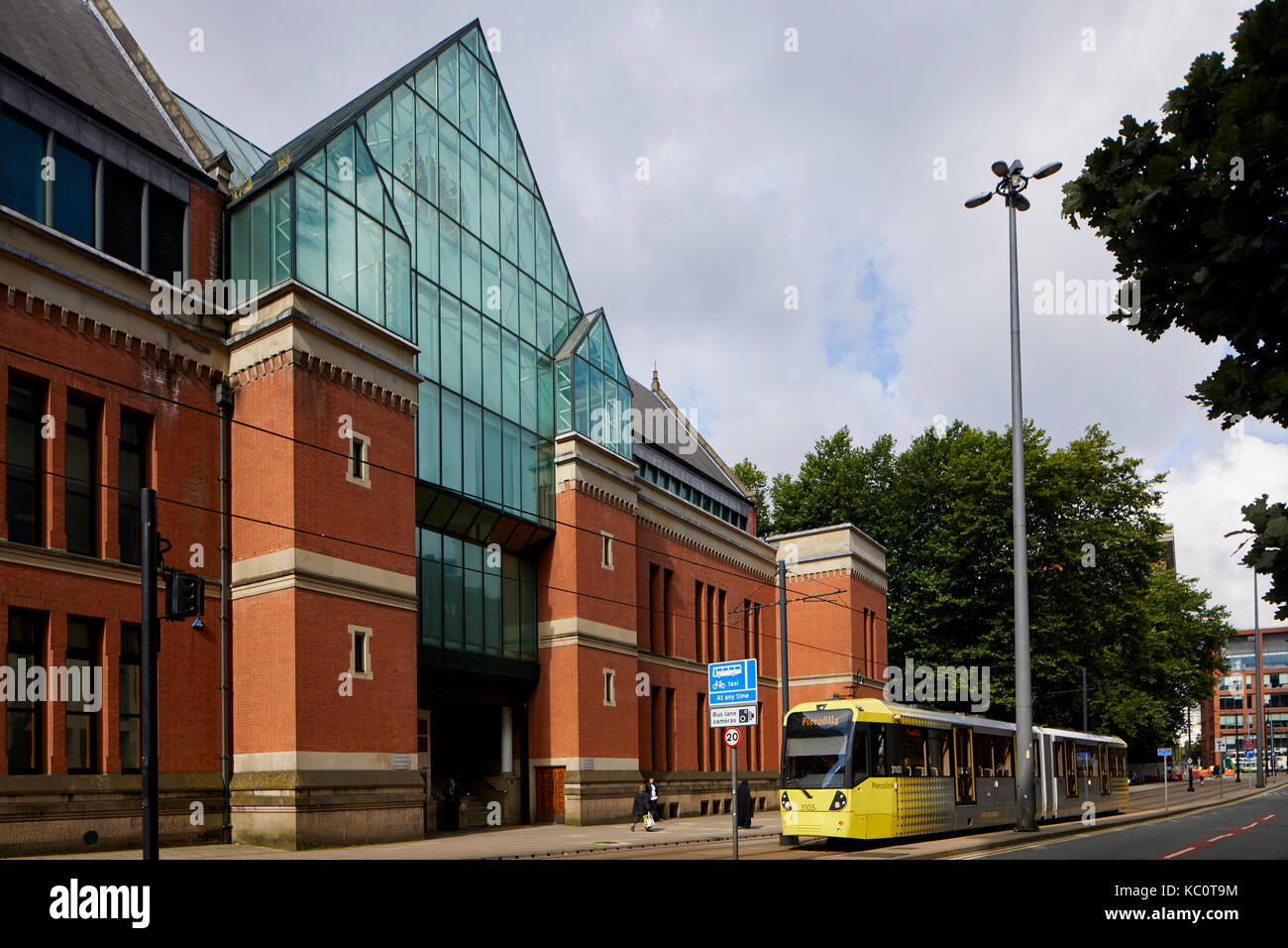 Metrolink tram M5000 model passing Minshull Street Crown Court by architect Thomas Worthington in the Flemish Gothic style Stock Photo