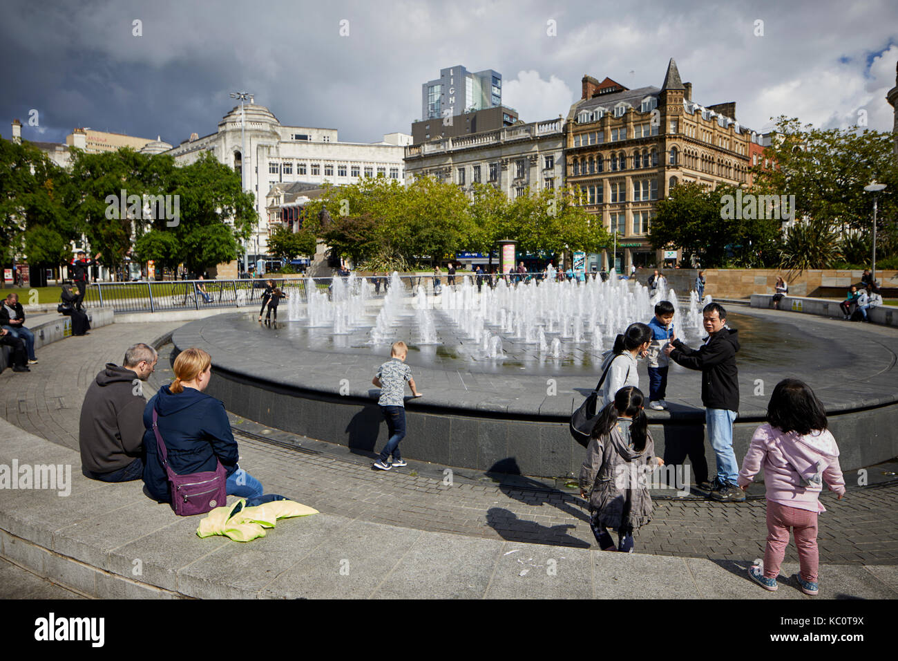 Manchester Piccadilly Gardens water fountain feature admired by children Stock Photo