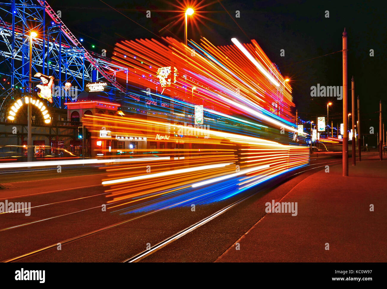 Illuminated tram passing the Pleasure Beach during the annual  illuminations,Blackpool,Lancashire,UK Stock Photo