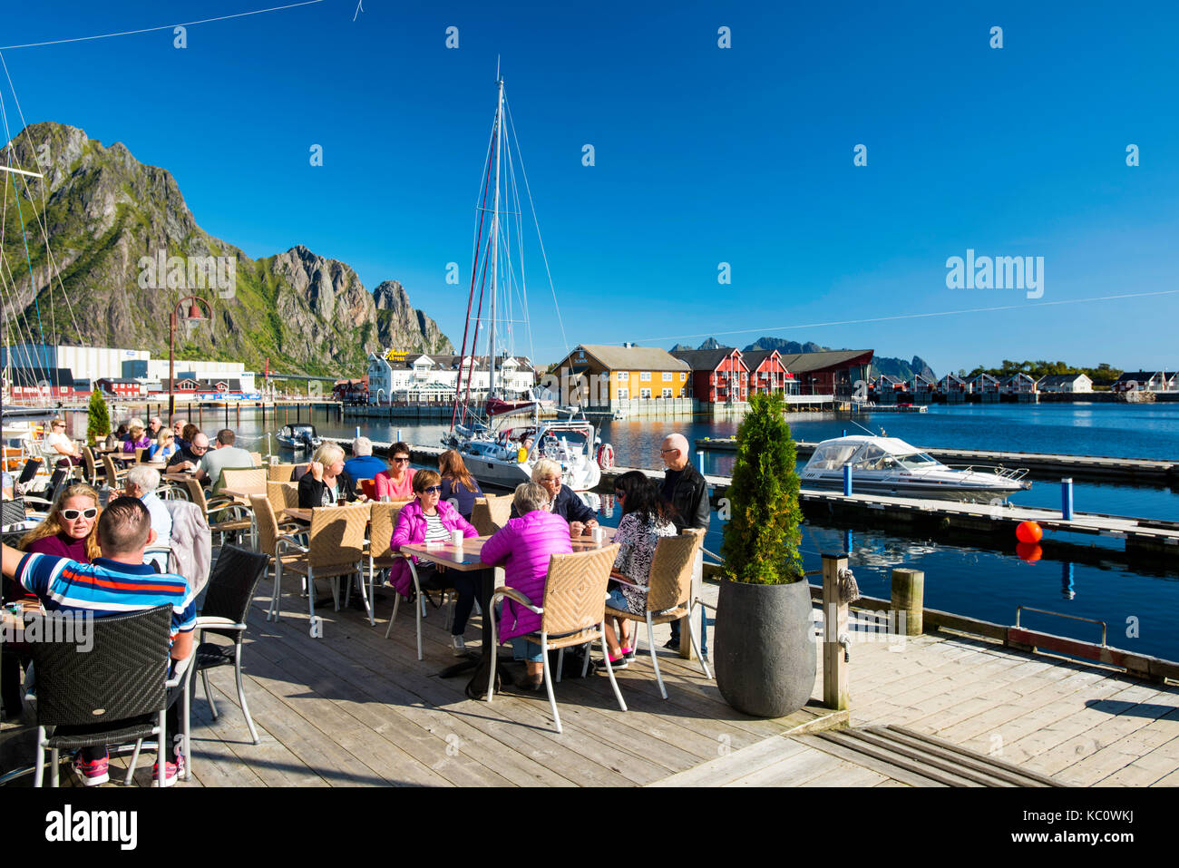 Guests having lunch on the terrace at Bacalao restaurant on the waterfront in Svolvær, Lofoten, Norway Stock Photo
