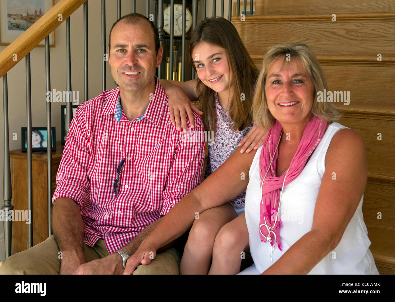 Simon & Gail Abdilla with daughter Sophie, with their new self-build house in Exton, Devonshire, UK Stock Photo
