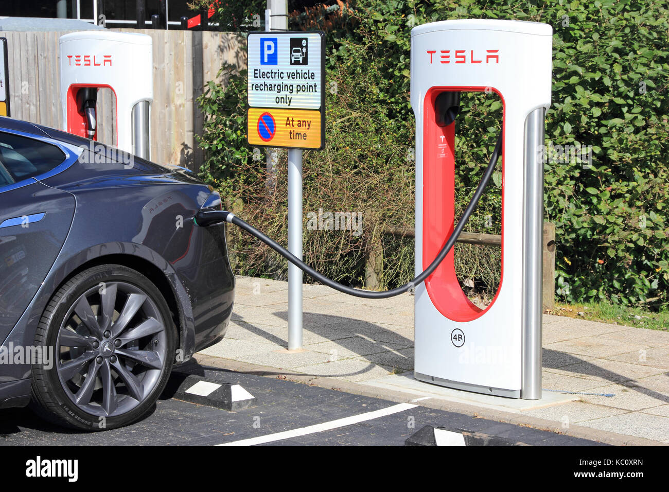 Tesla electric car charging at dedicated charging point at Hopwood Motorway Services, Alvechurch, Birmingham Stock Photo