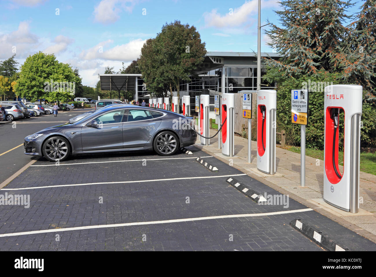 Tesla electric cars charging at dedicated charging points, Hopwood