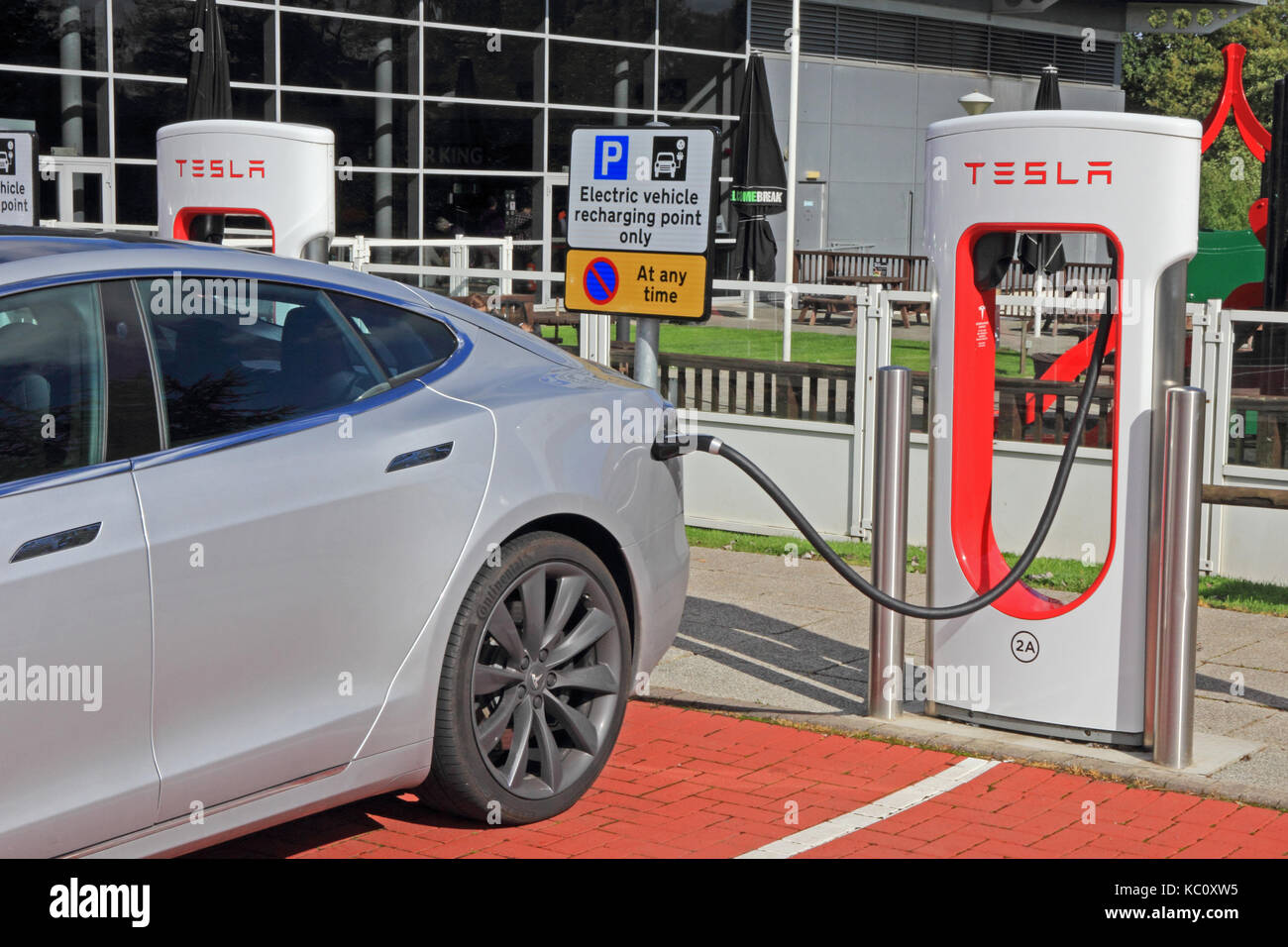 Tesla electric car charging at dedicated charging point at Hopwood