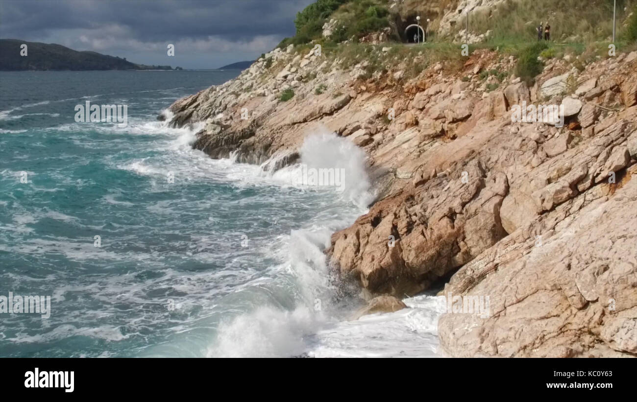 The waves breaking on a stony beach, forming a spray. Footage ...