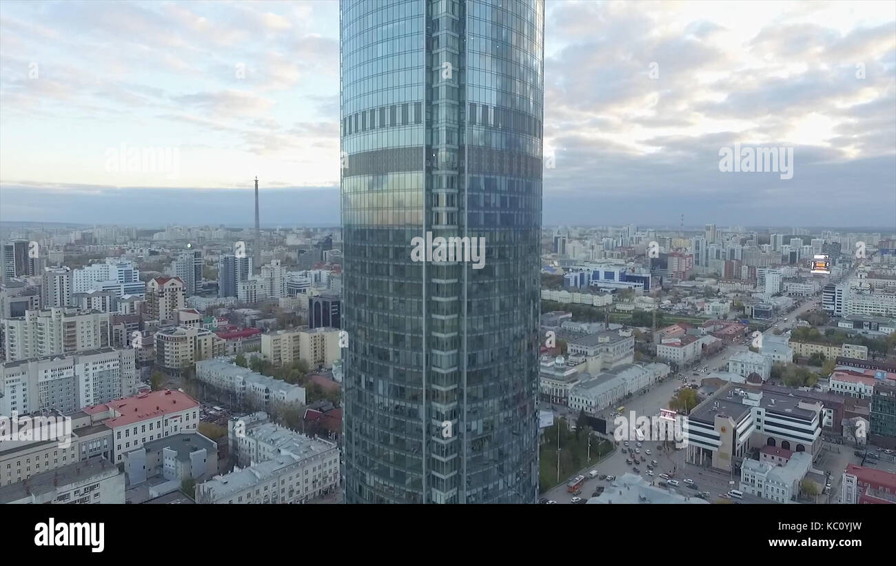 Flying over skyscraper and very beautiful city view.Aerial survey of skyscraper of big bilding in Russia.A modern business center. Overhead Aerial Flight Over Rooftops Skyscrapers, Urban Landscape Stock Photo