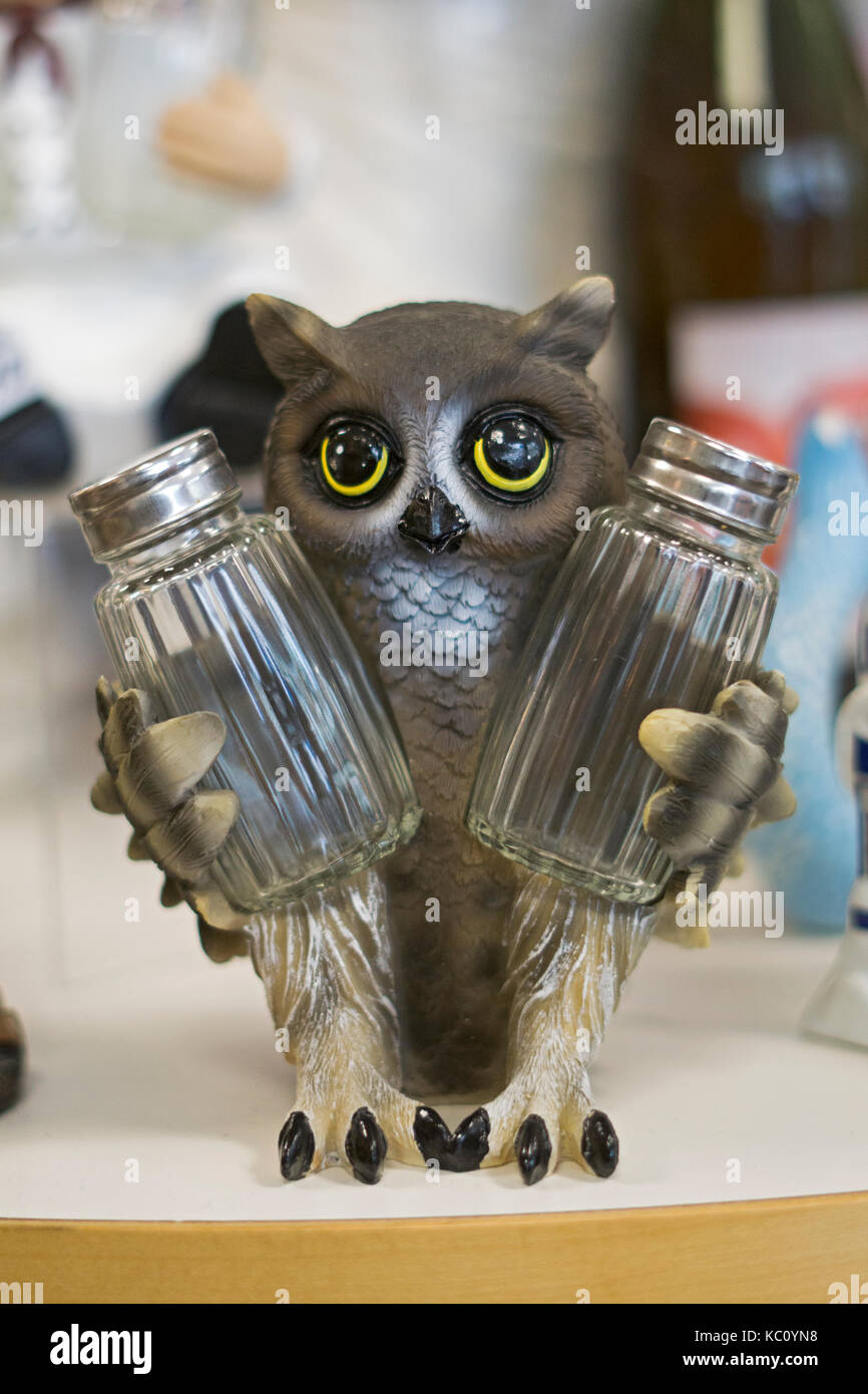 An owl holding salt and pepper shakers for sale at Gizmos & Gadgets at the Tanger Outlet Mall in Deer Park, Long Island, New York. Stock Photo