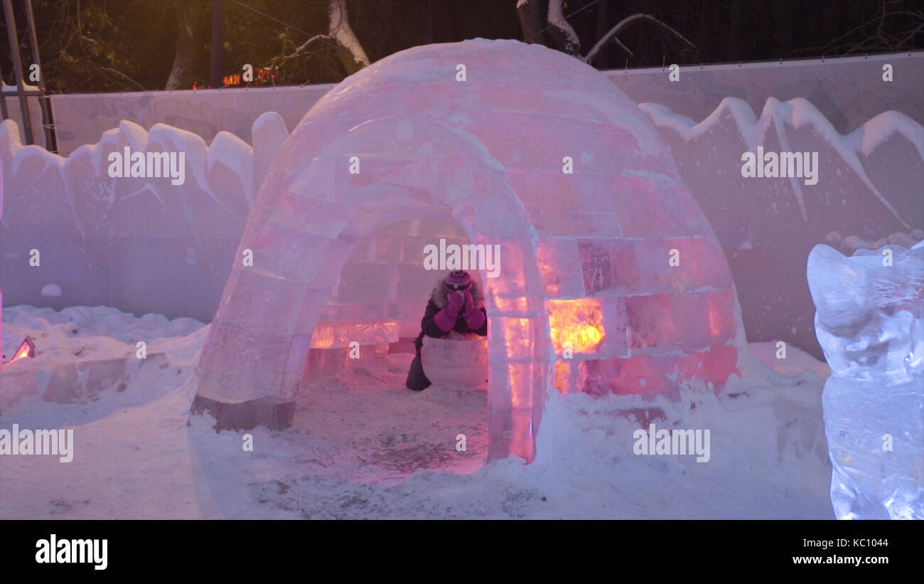 People and baby Walk In Ice Town During Snowfall. Children plays at the ...