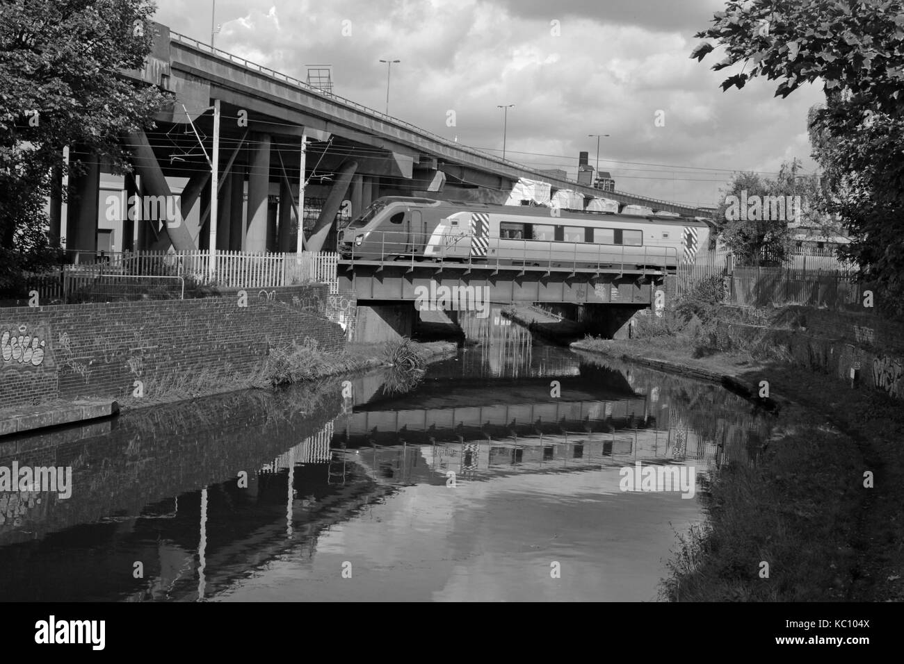 Cw 4098  A Virgin train crosses a canal at Spon Lane near Smethwick.  A Virgin diesel multiple unit passenger train crosses a canal deep in the heart  Stock Photo