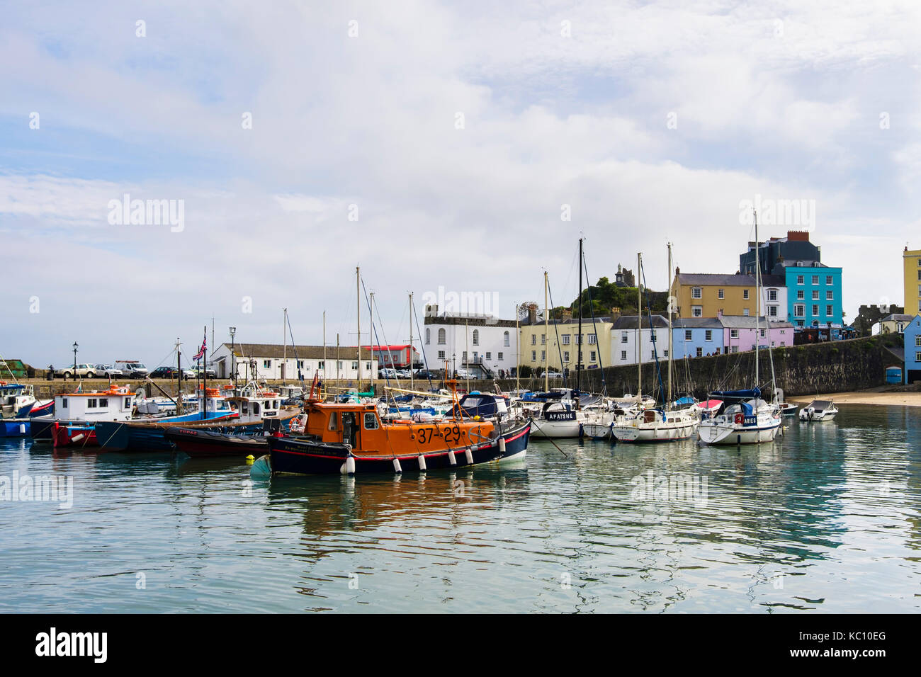 Boats and lifeboat moored in the old harbour at high tide. Tenby, Carmarthen Bay, Pembrokeshire, Wales, UK, Britain Stock Photo