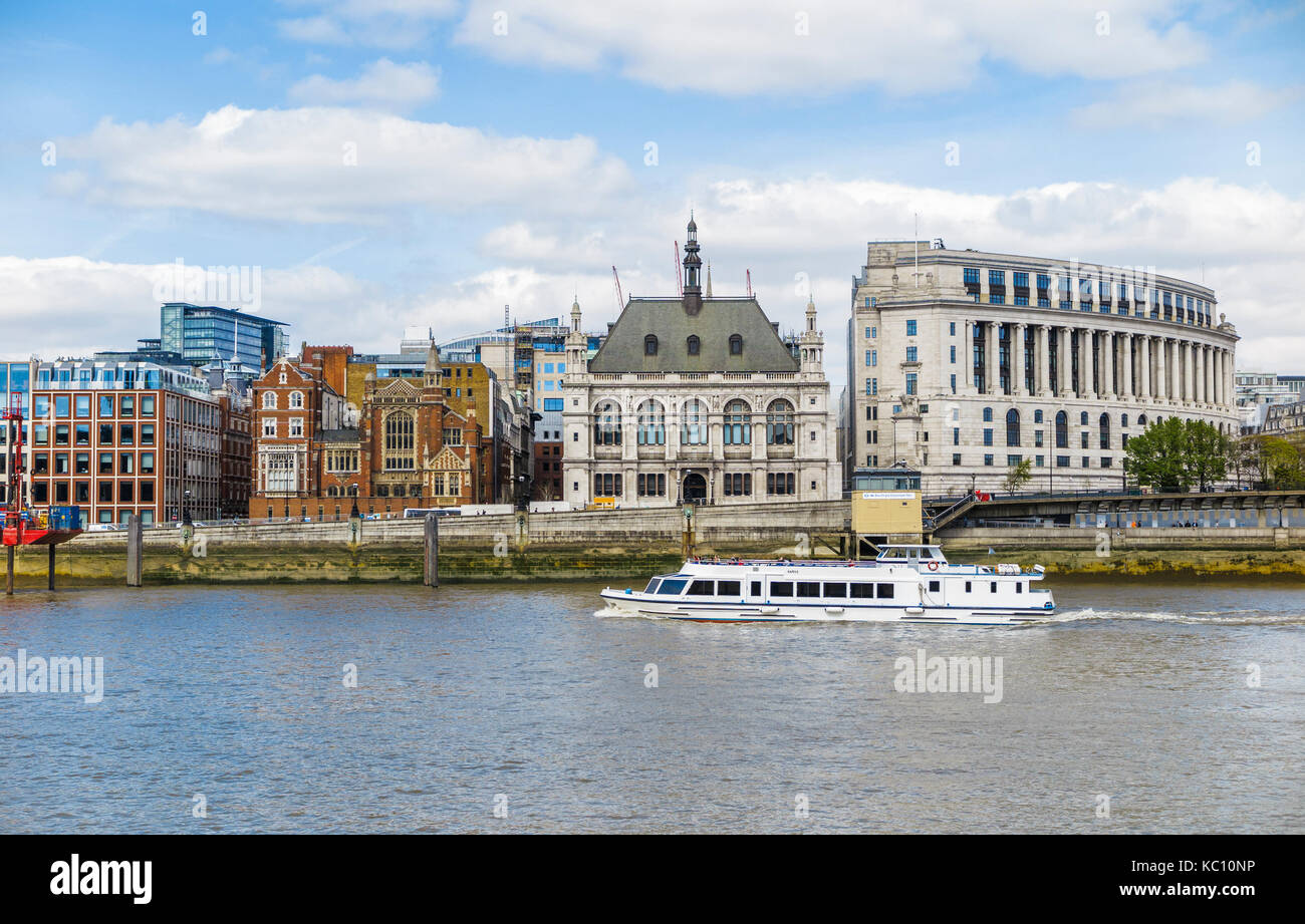 White river cruise tourist sightseeing boat sails along the River Thames by Unilever House and 60 Victoria Embankment, London EC4 on a sunny day Stock Photo