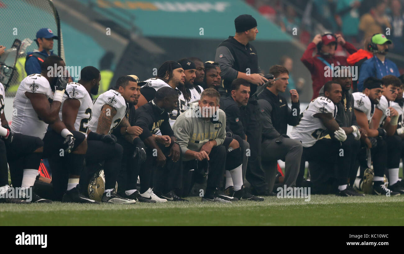 New Orleans Saints' head coach Sean Payton (centre) joins his team in  taking a knee prior to the American National Anthem prior to the NFL  International Series match at Wembley Stadium, London
