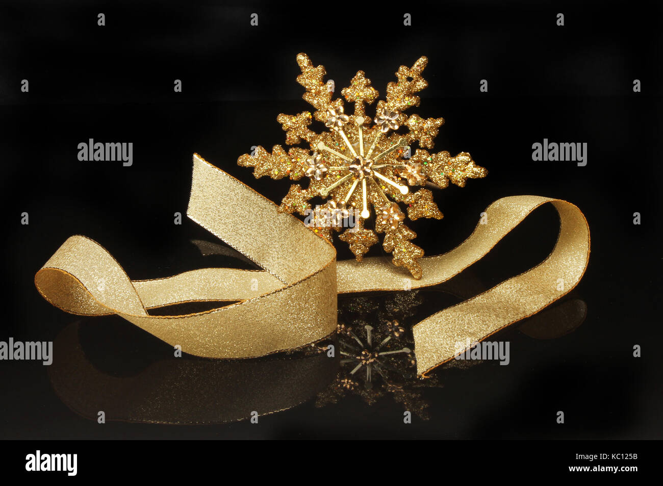 Gold glitter Christmas star decoration and ribbon with reflections ...