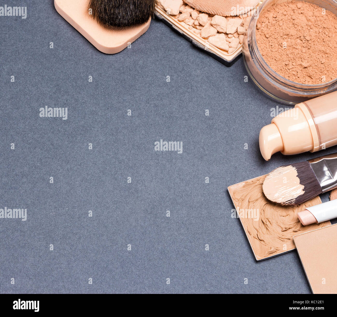 Frame of corrector, open liquid foundation bottle, jar of loose powder