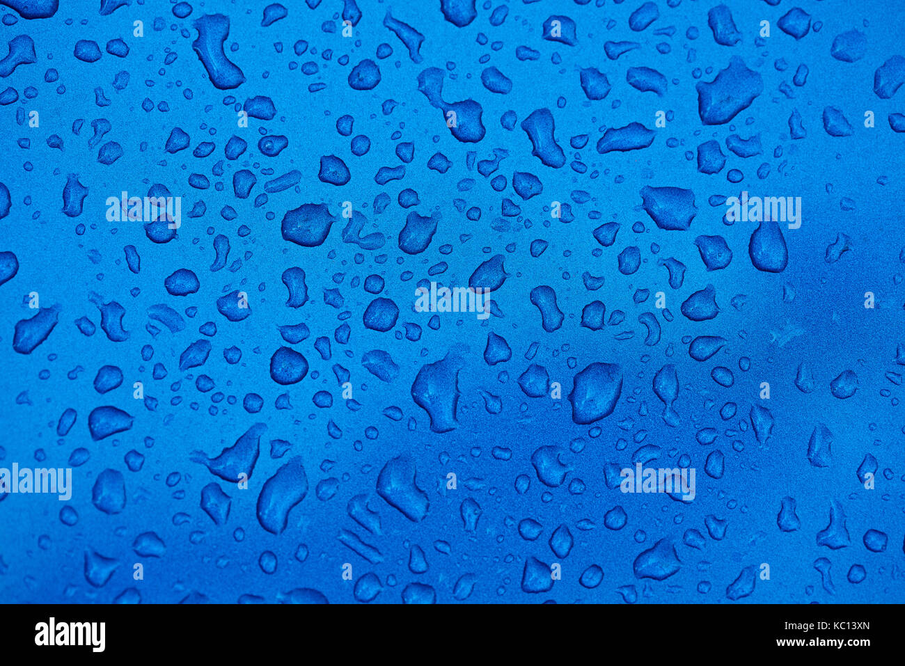 Close-up of water drops on blue matte metal background. Macro of water drops Stock Photo
