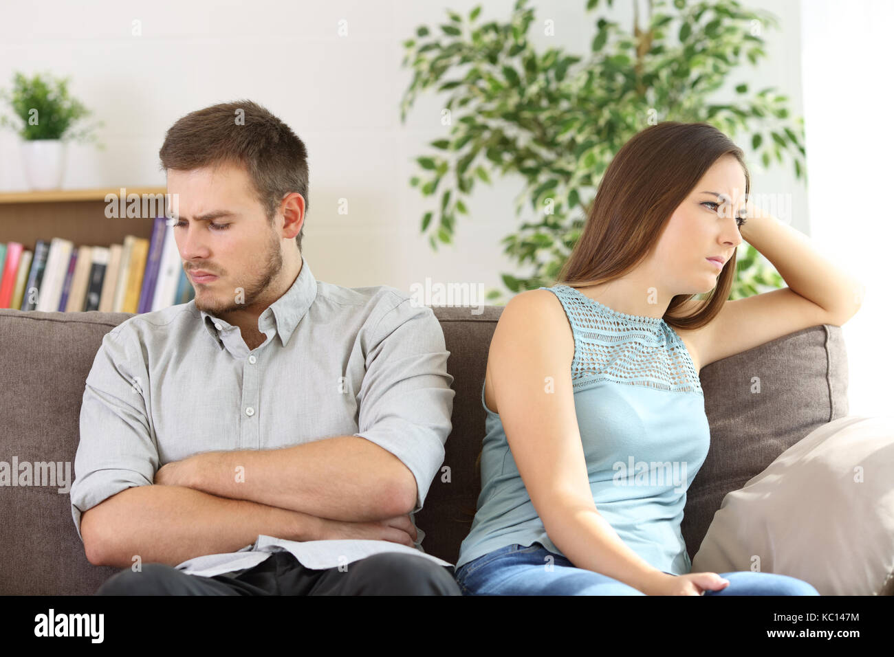 Angry couple ignoring each other after argument sitting on a sofa at home Stock Photo