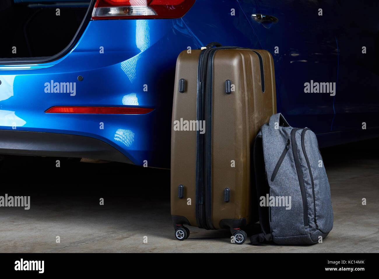 Baggage bags loading to car trunk closeup. Loading luggage in modern