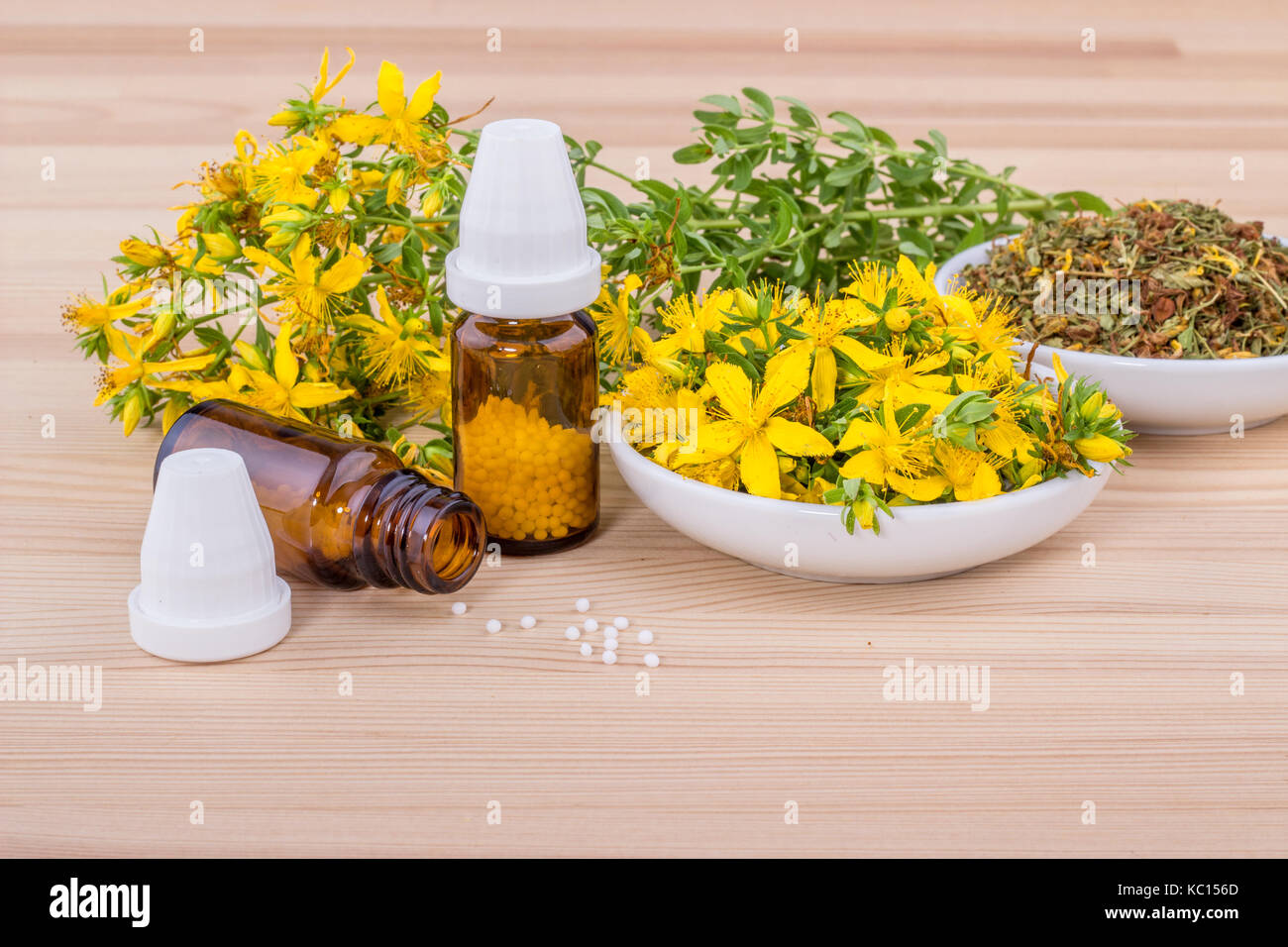 Homeopathic remedy with flowering and dried St. John's wort on wooden ground Stock Photo