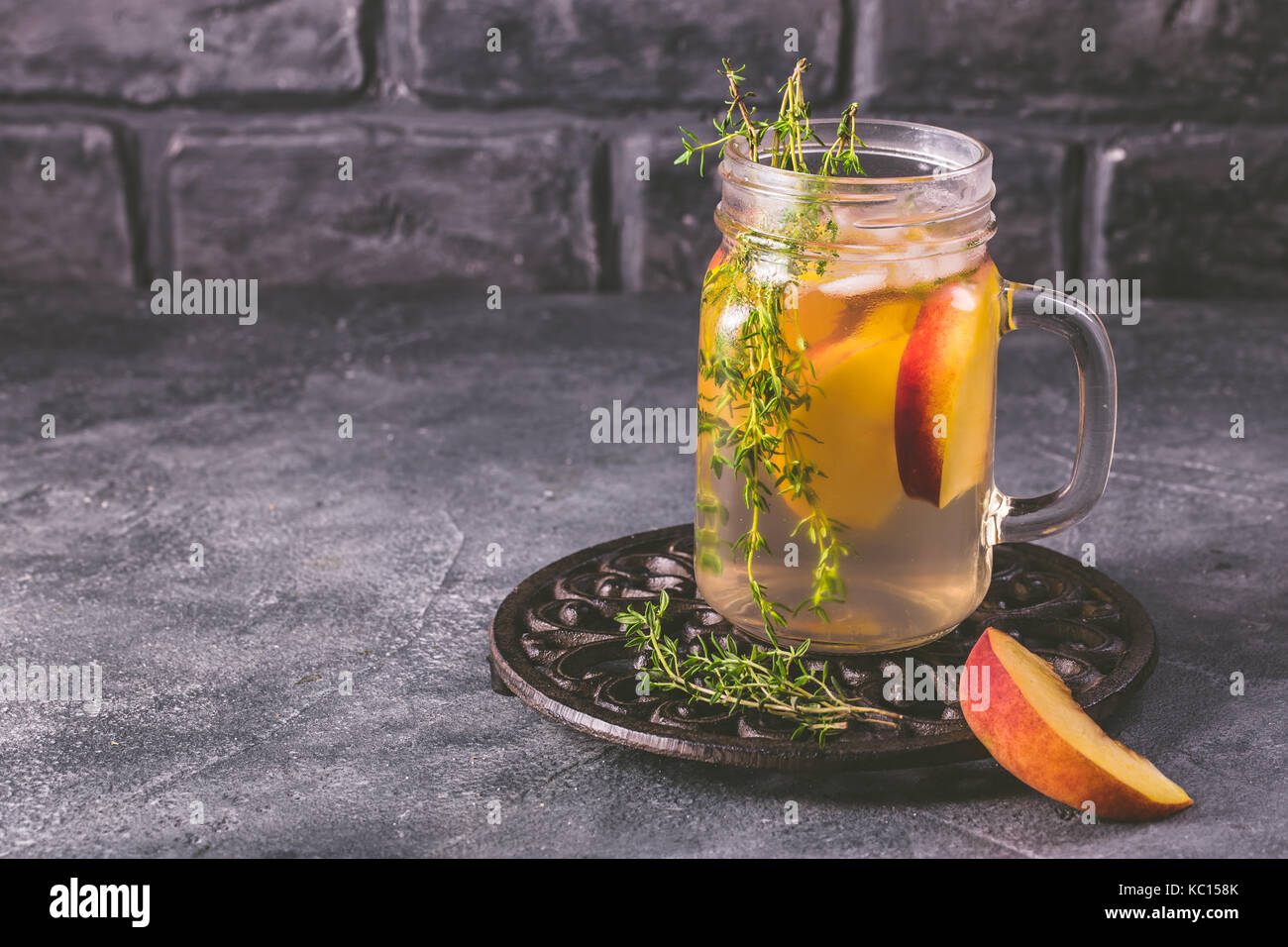 Water infused with peach and thyme Stock Photo