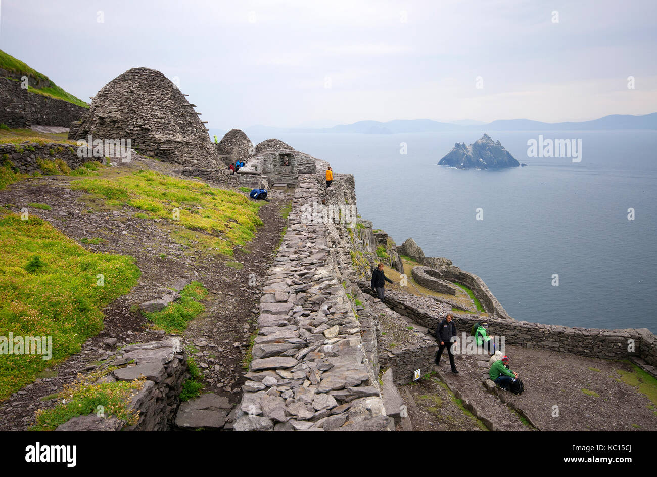 Visitors at ancient monastery at Skellig Michael Island (in the background Little Skellig), County Kerry, Ireland Stock Photo