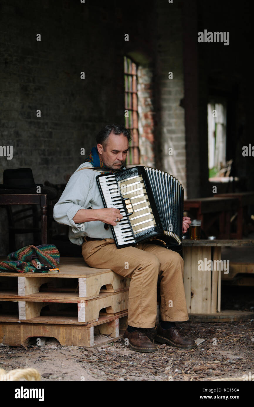 Composer, multi-instrumentalist and sound artist, Roger Eno, playing the accordion at an arts festival in Norfolk UK, May 2017. Stock Photo
