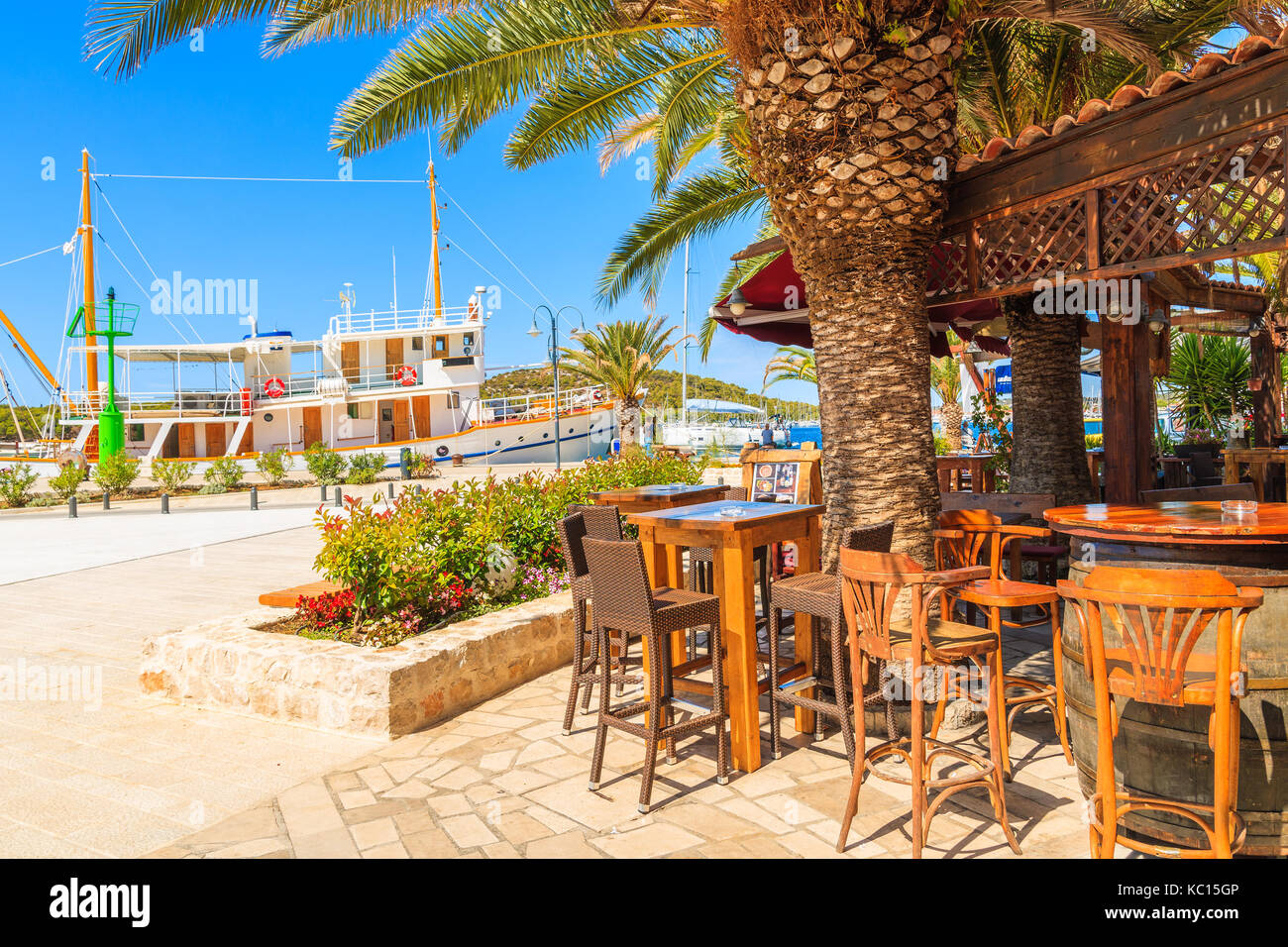 ROGOZNICA PORT, CROATIA - SEP 4, 2017l Traditional bar in Rogoznica port with sailing boat in background, Dalmatia, Croatia. Stock Photo