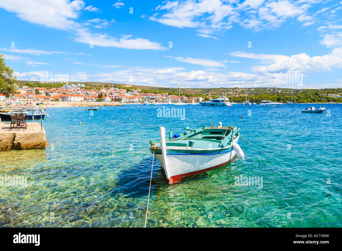 Colorful fishing boat on turquoise sea water in Primosten port, Dalmatia, Croatia Stock Photo