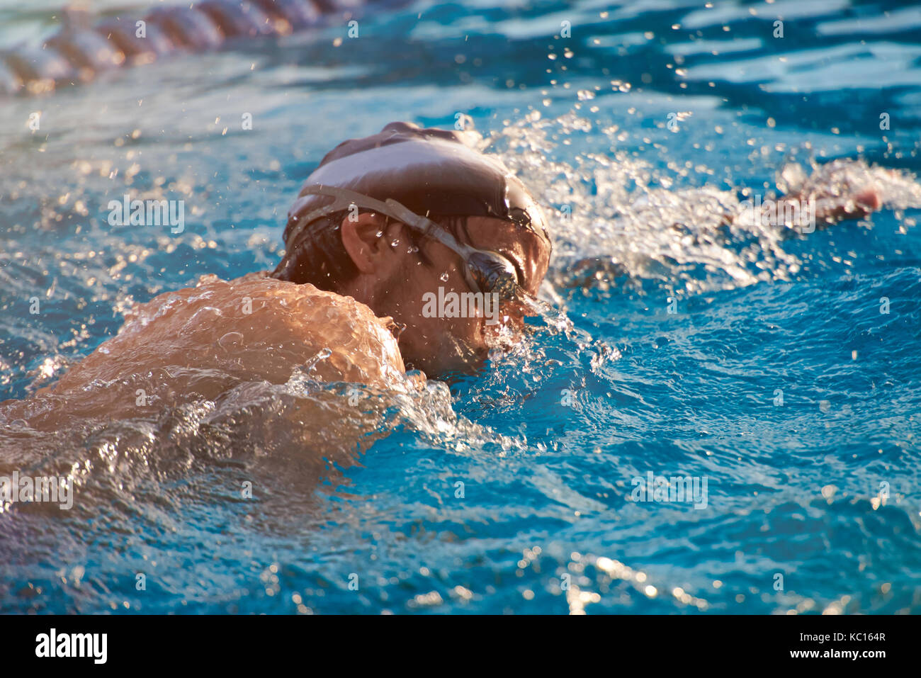 Man take part in swimming competition close up. Fast swimming man in pool water Stock Photo