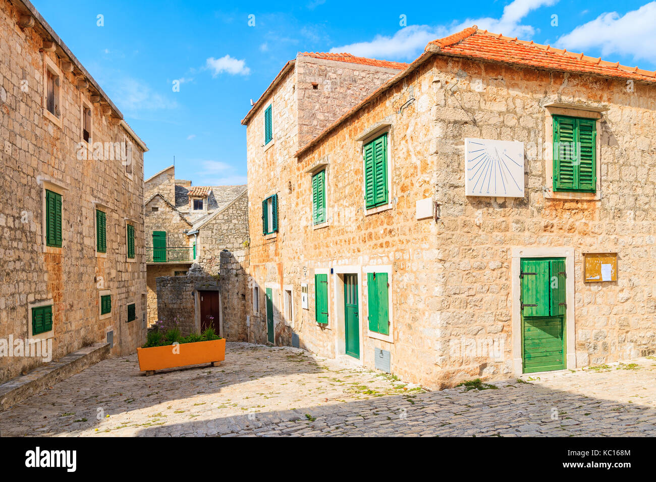 POSTIRA TOWN, CROATIA - SEP 7, 2017: Street with typical stone houses in Postira old town, Brac island, Croatia. Stock Photo