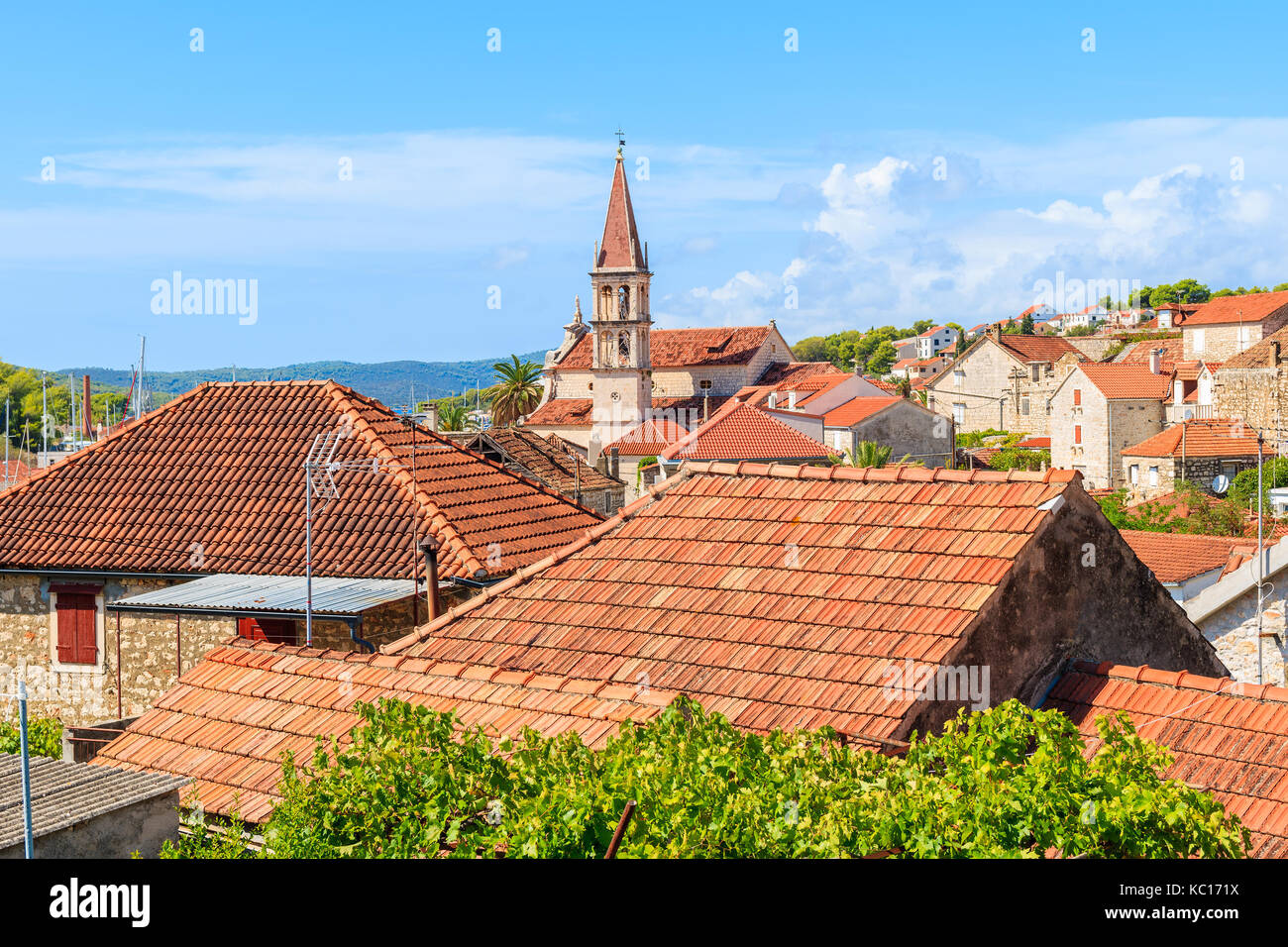 View of Milna town with orange tile roofs and beautiful church tower in center, Brac island, Croatia Stock Photo