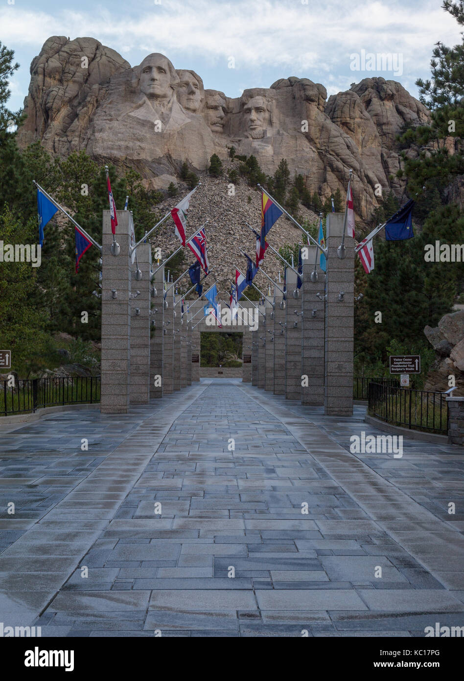 Deserted walkway of state flags leading up to Mount Rushmore at the