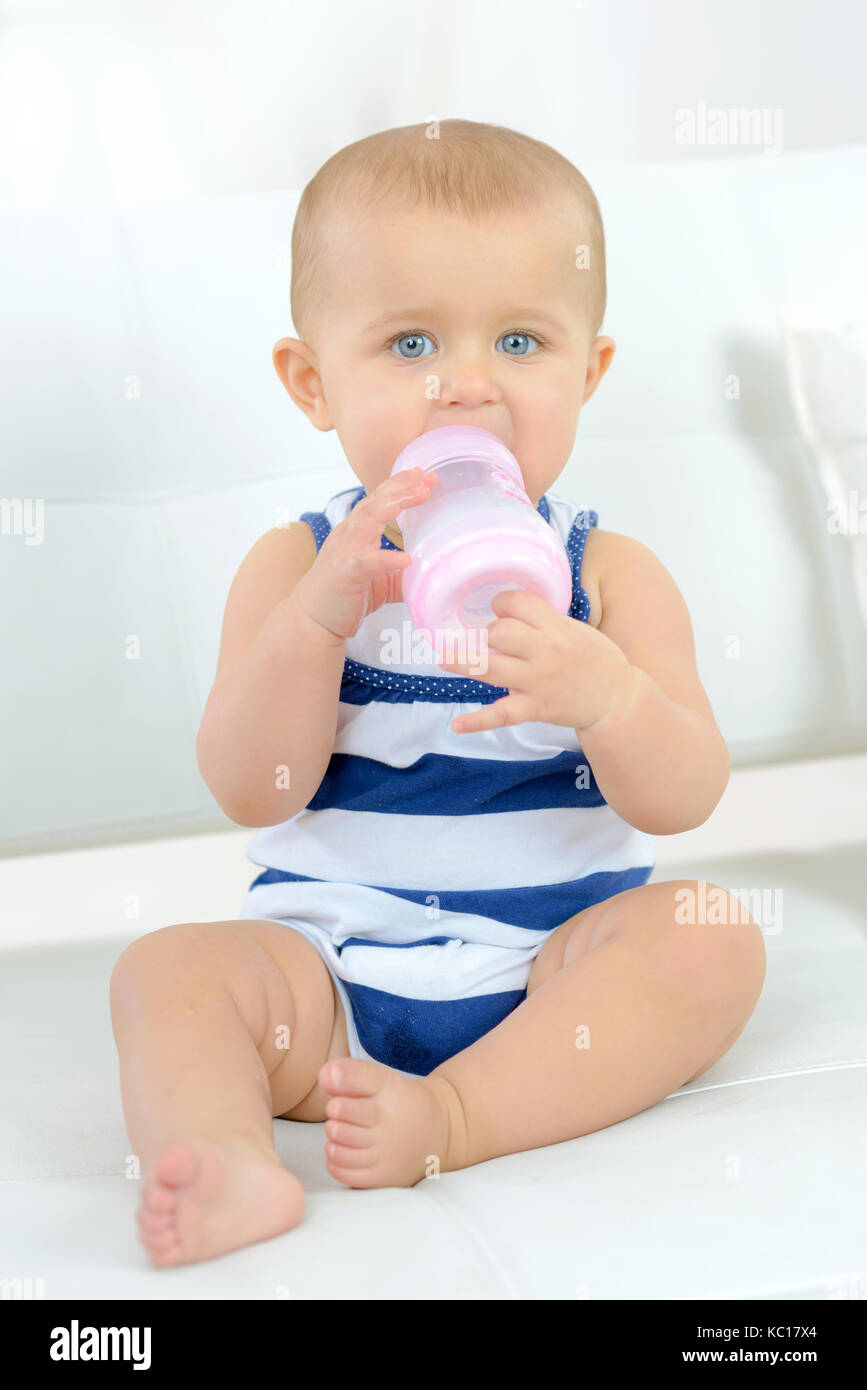 baby drinking milk from bottle Stock Photo Alamy