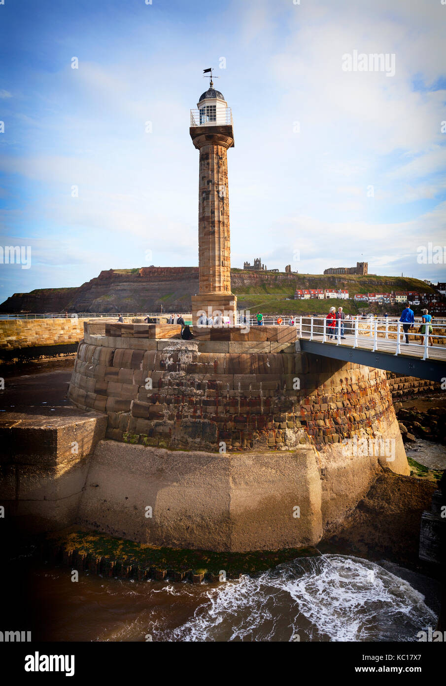 The West pier lighthouse with its fluted Grecian column completed in October 1831 at Whitby  harbour entrance, Yorkshire, England Stock Photo