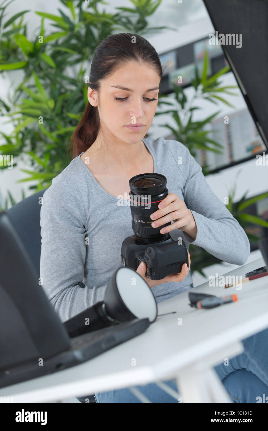 beautiful young female photographer checking pictures