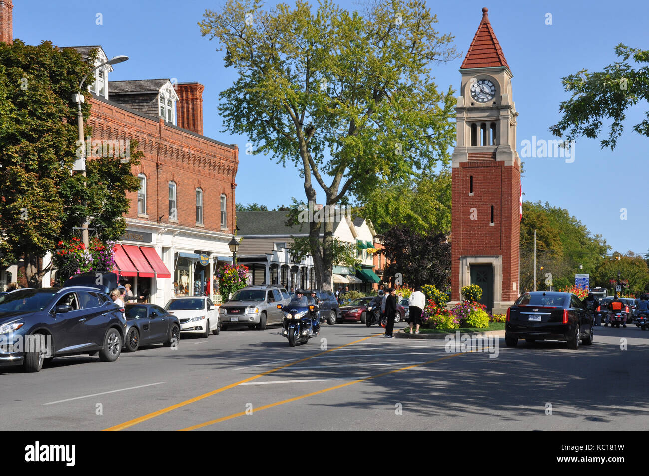 Niagara-on-the-Lake, Ontario, Canada - September 10, 2017 - Street View with People and Bicycles sitting on a Porch of a Tourist Inn - Editorial Stock Photo