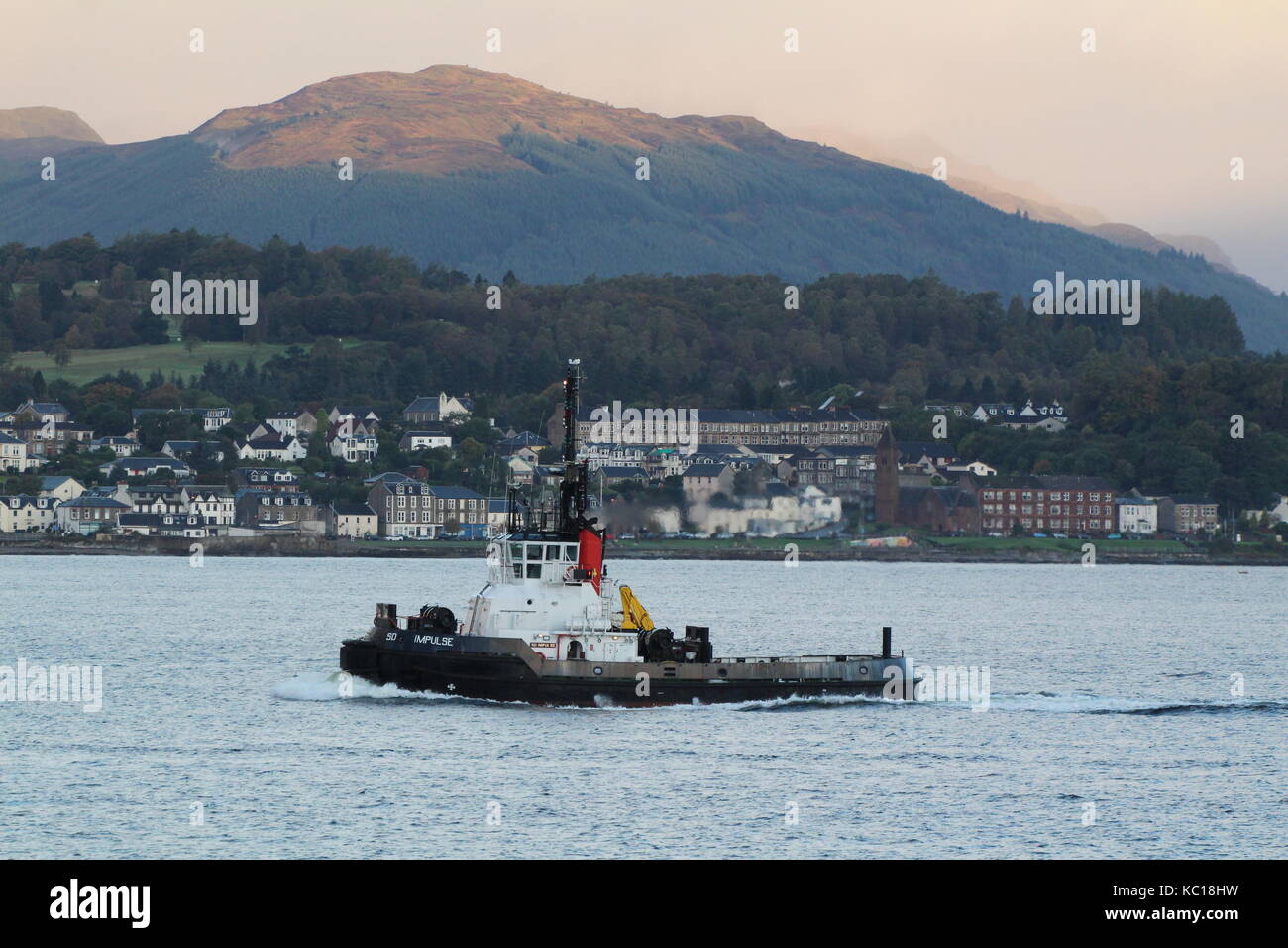 SD Impulse, a Clyde-based Impulse-class tug operated by Serco Marine Services, passing Gourock during the arrivals for Exercise Joint Warrior 17-2. Stock Photo