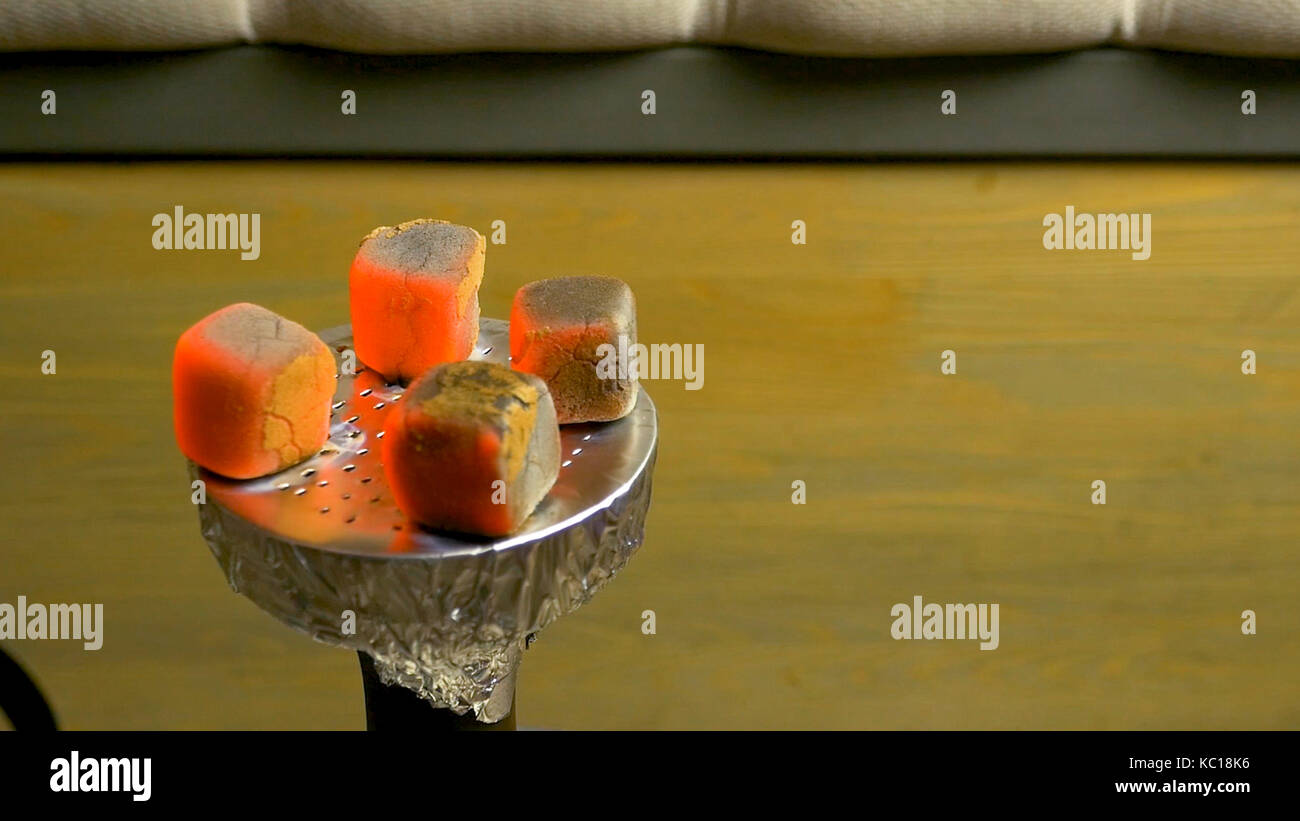 Sparks from the burning coals hookah. Hookah tobacco in bowl. Blazing