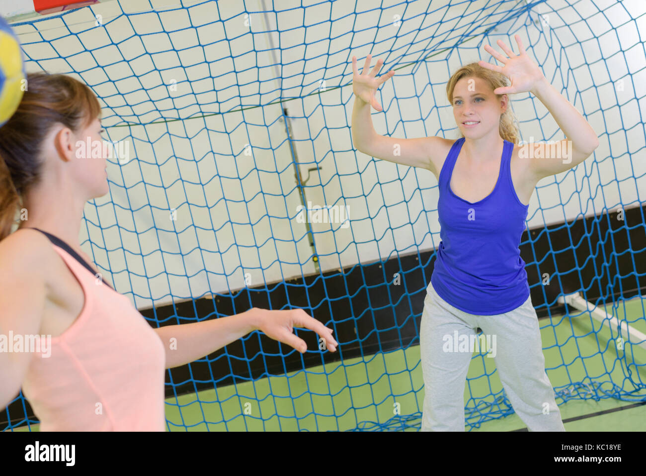 sportswoman holding a ball against handball field indoor Stock Photo