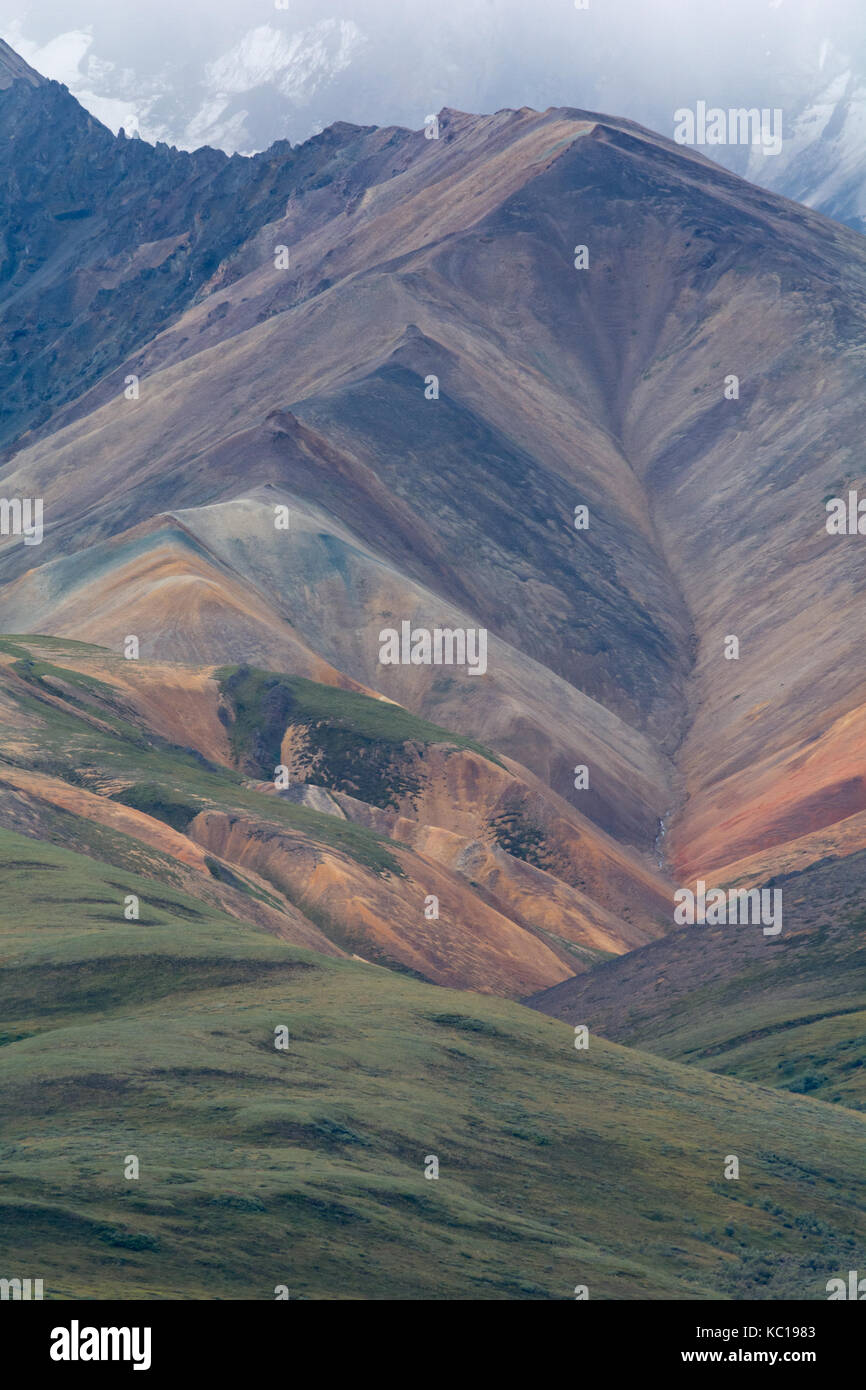 A harsh climate and young mountains resulted in a triangluar hillside as the overlying rock was striped away. Stock Photo