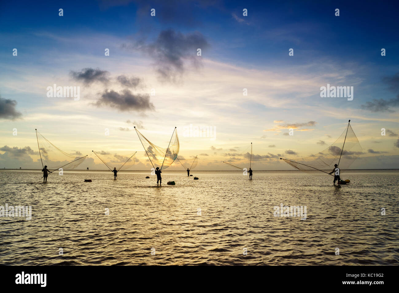 There are many fishermen are fishing on the beach in dawn, Mekong Delta, Bac Lieu, Vietnam Stock Photo