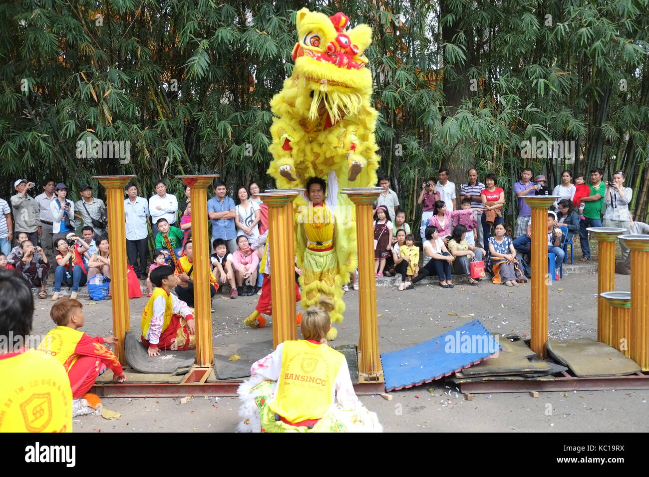 Saigon - Feb 03, 2014: Lion dancing on flower pillars (Mai Hoa Thung) at Tao Dan Park, Ho Chi Minh city, Vietnam at the Lunar New Year. Stock Photo