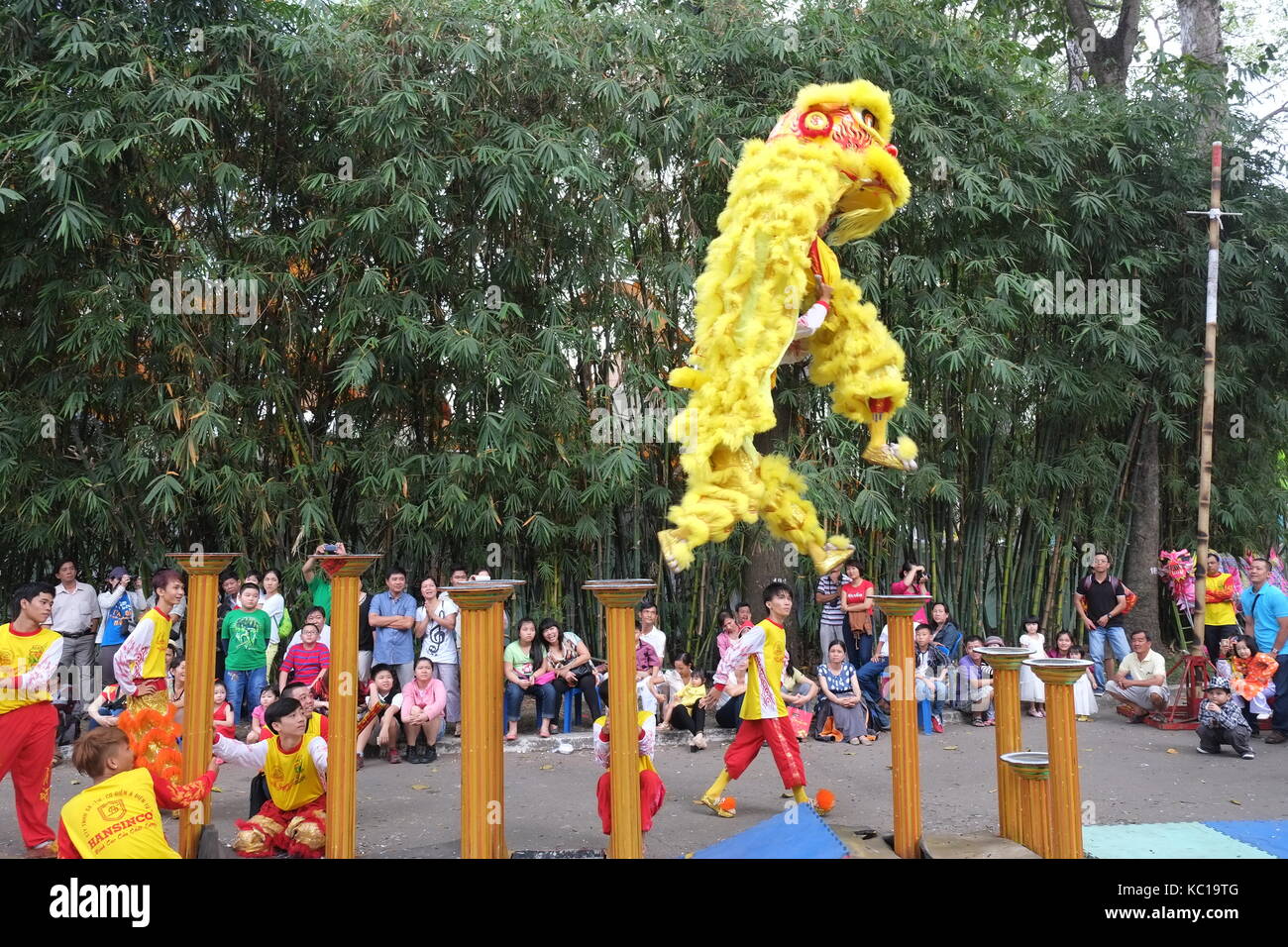 Saigon - Feb 03, 2014: Lion dancing on flower pillars (Mai Hoa Thung) at Tao Dan Park, Ho Chi Minh city, Vietnam at the Lunar New Year. Stock Photo