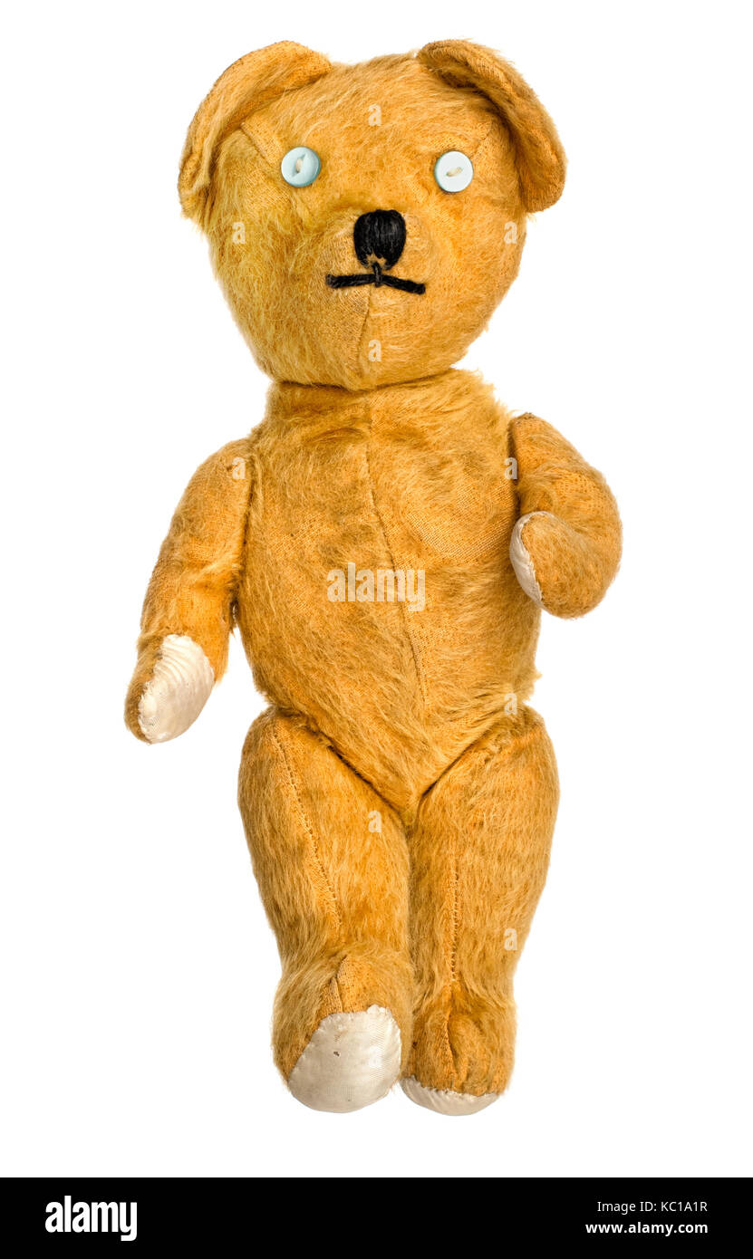Old, much loved, much repaired, unbranded toy teddy bear isolated on white. Stock Photo