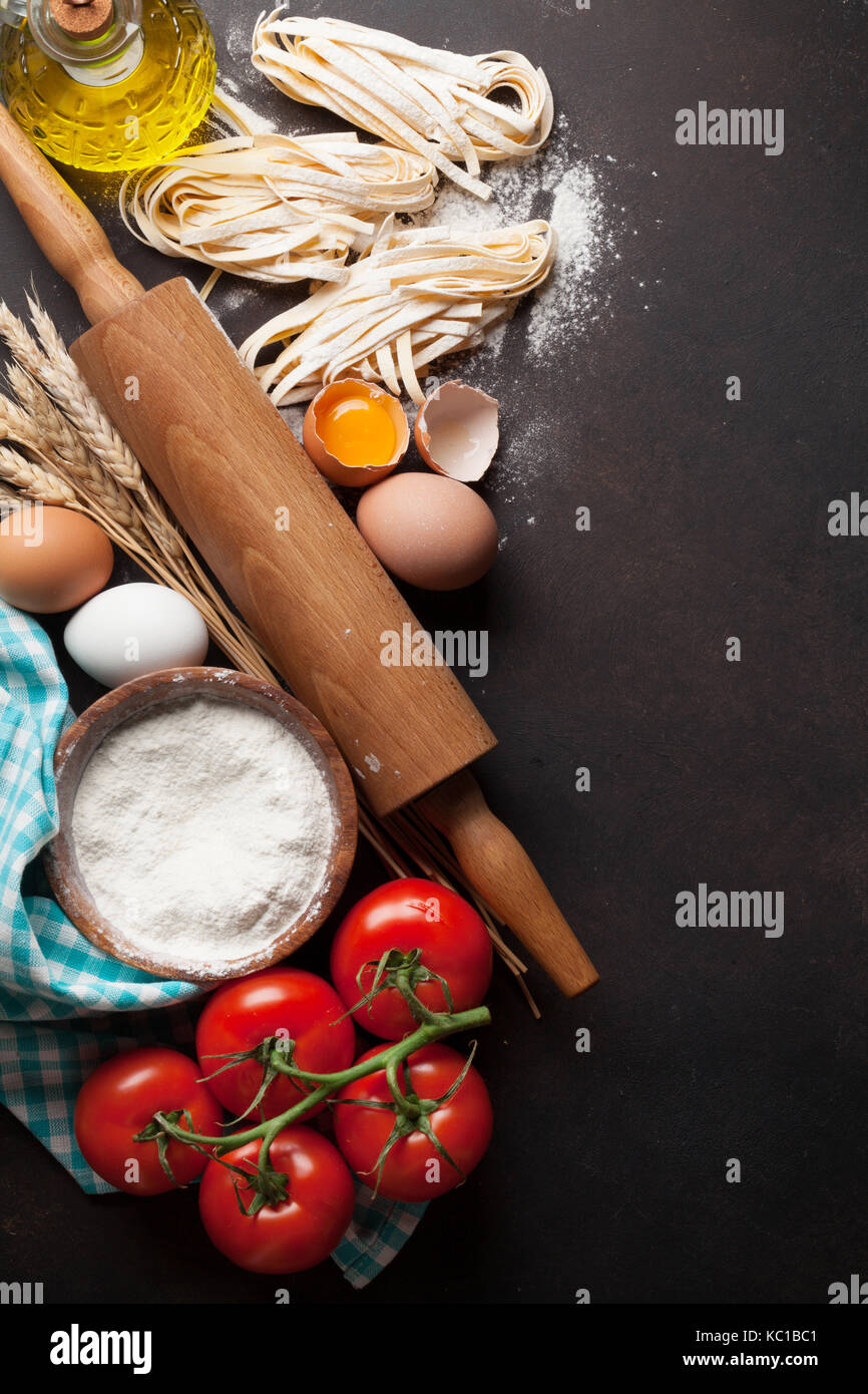 Pasta cooking ingredients on wooden kitchen table. Top view with space ...