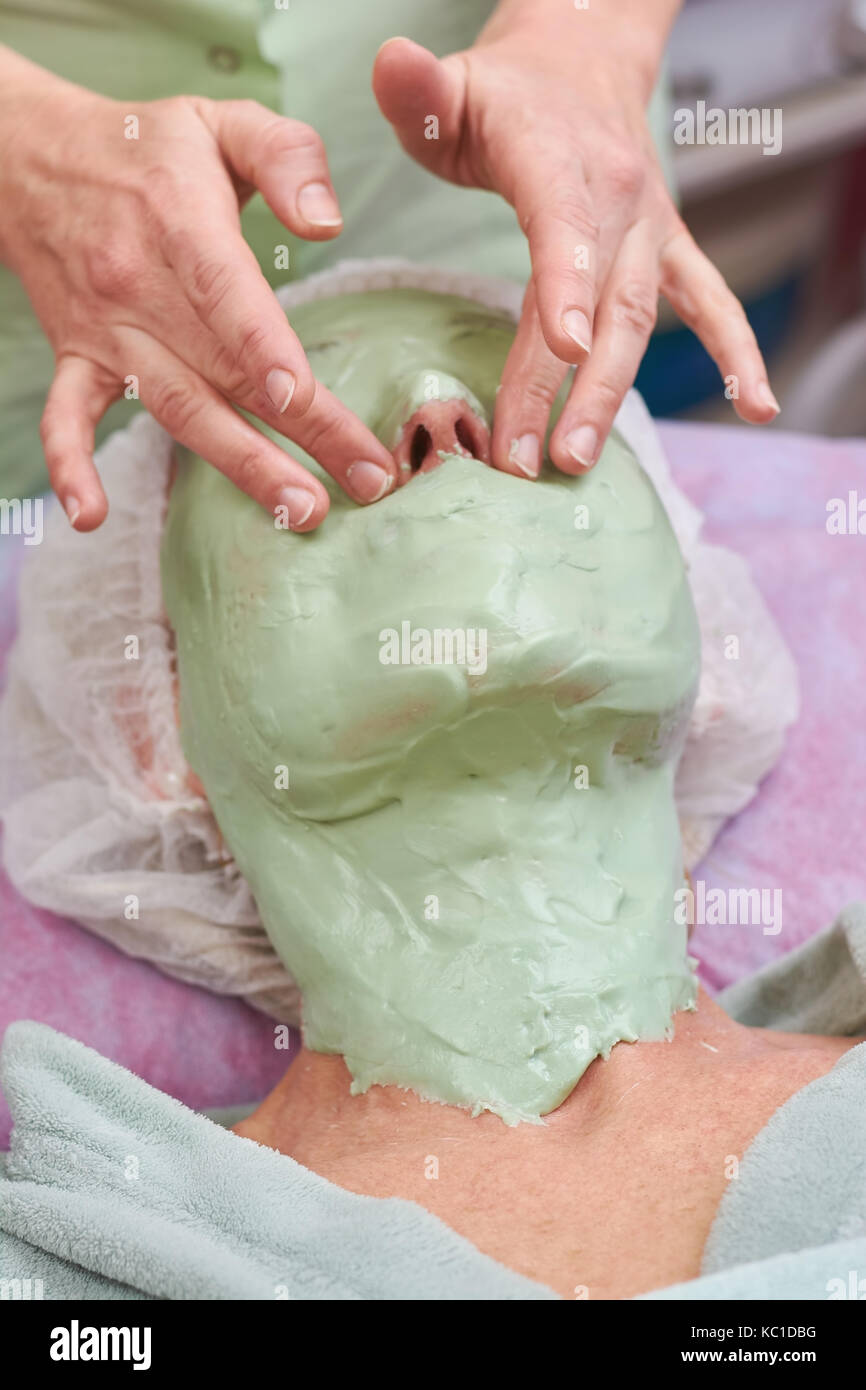 Hands of cosmetician, facial mask. Stock Photo