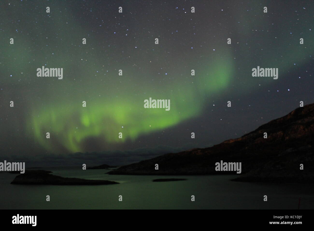Northern lights over mountains and fjords in Tromso Stock Photo - Alamy