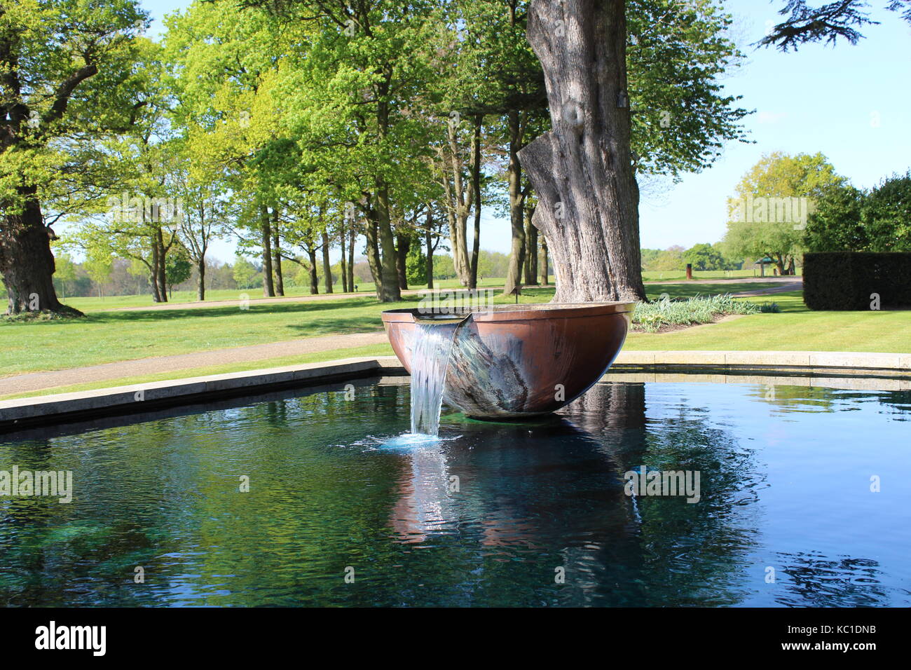 copper water fountain in a pond Stock Photo Alamy